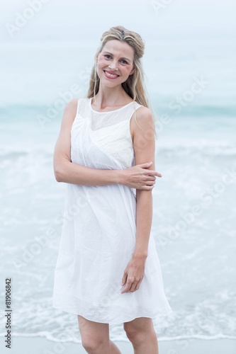 Smiling blonde in white dress looking at camera © WavebreakmediaMicro