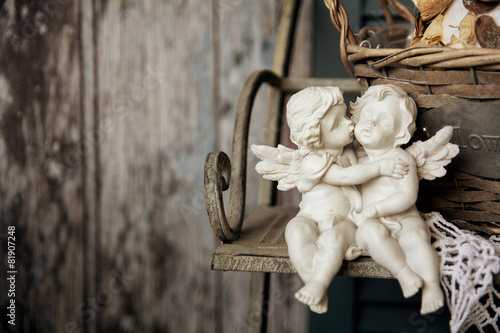 Figurines angels sitting on a bench