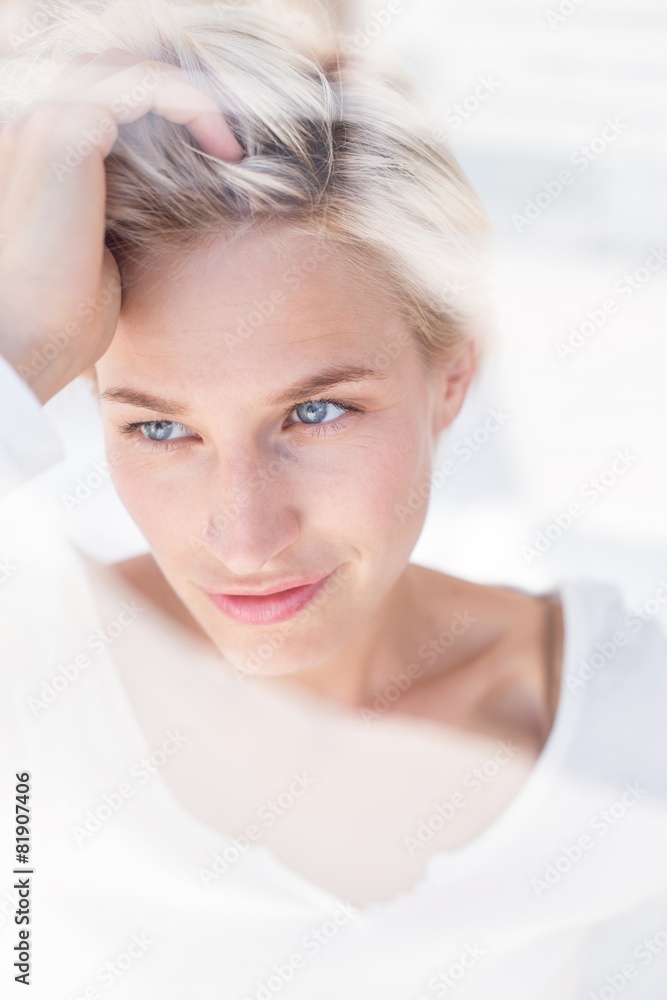 Thoughtful blonde woman looking through the window Thoughtful blonde woman looking through the window
