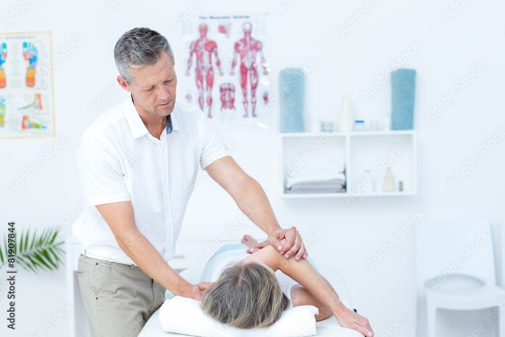 Physiotherapist doing back massage to his patient Physiotherapist doing back massage to his patient