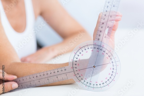 Doctor measuring wrist with goniometer