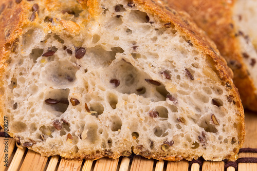 Brown bread with seeds on a table.