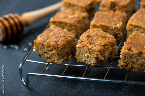 Homemade healthy flapjacks with honey on cooling rack photo