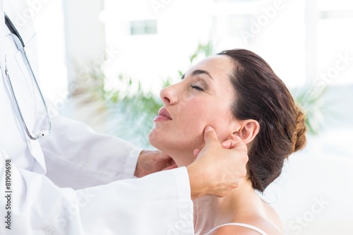 Doctor examining her patients jaw photo
