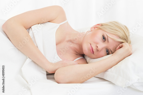 Sad woman in bed