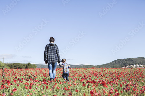 Mother and her little child having fun in a field