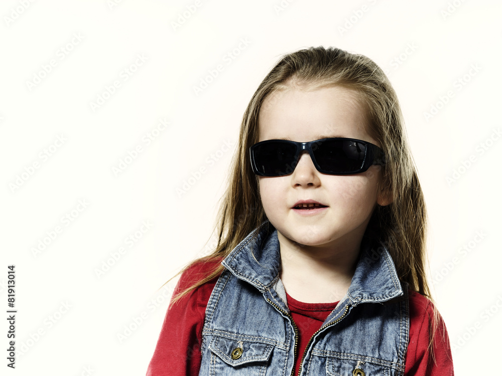 Cute little girl posing in mother's sunglasses, childhood concep