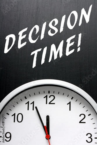 Decision Time concept with a clock and blackboard text