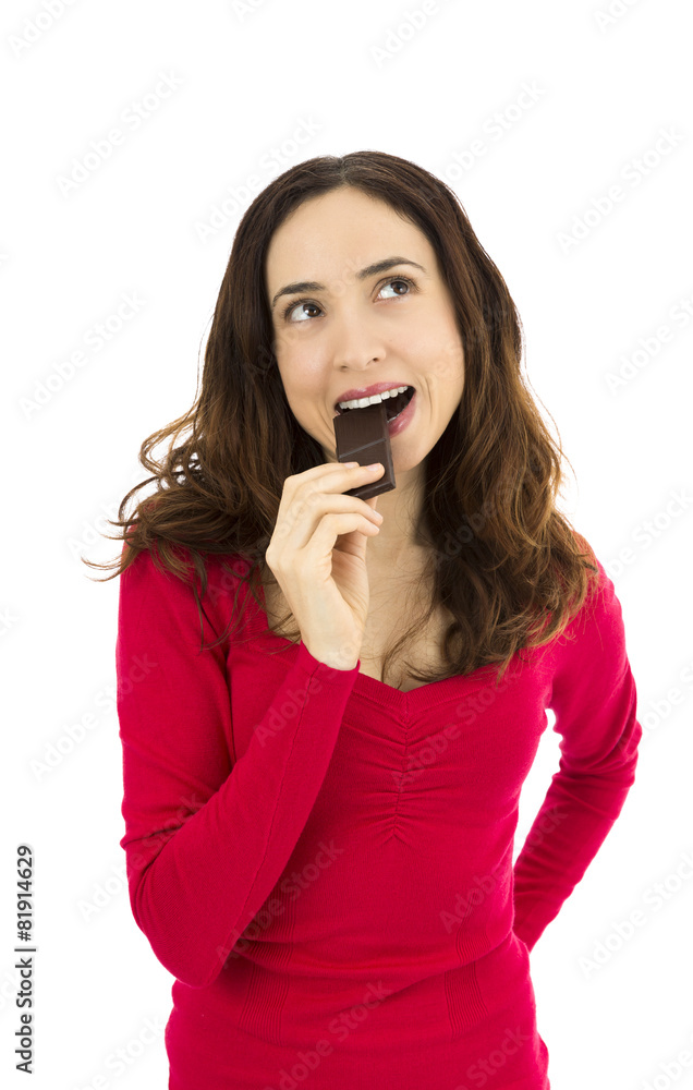 Beautiful woman eating chocolate and looking up to copy space Beautiful woman eating chocolate and looking up to copy space