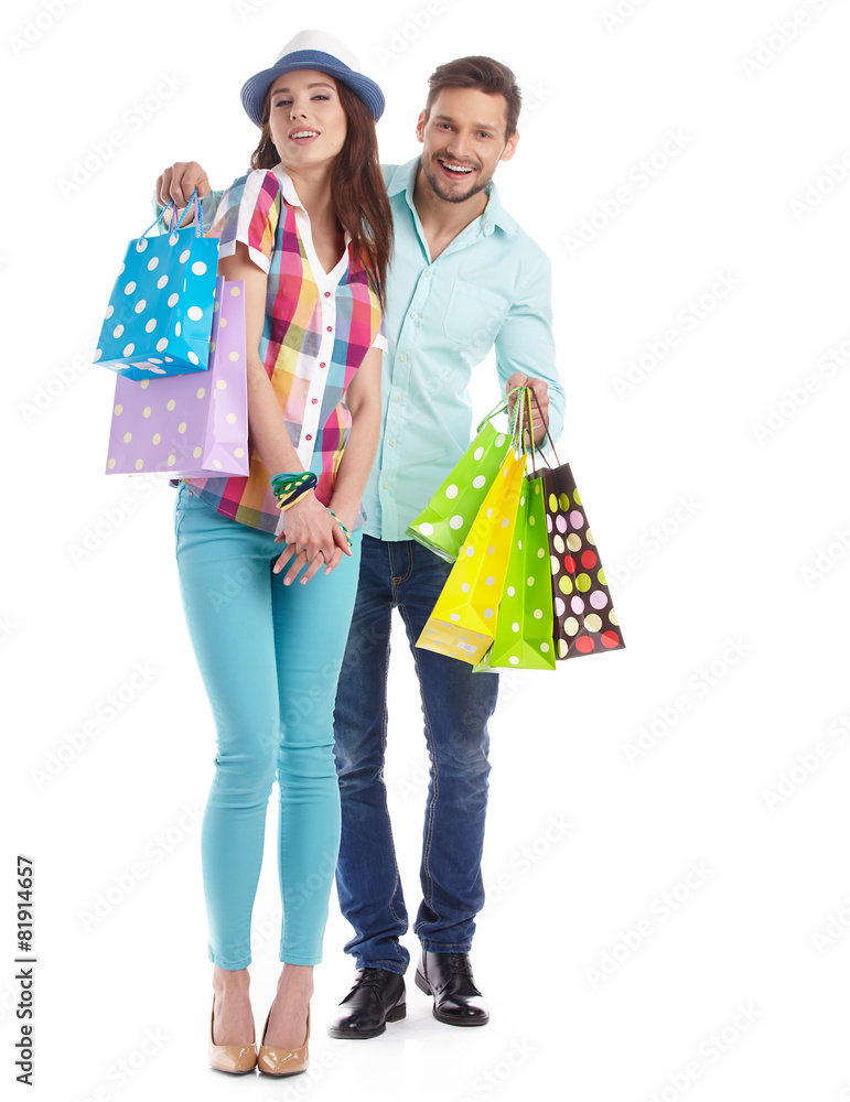Attractive young couple with shopping bags on white background Attractive young couple with shopping bags on white background