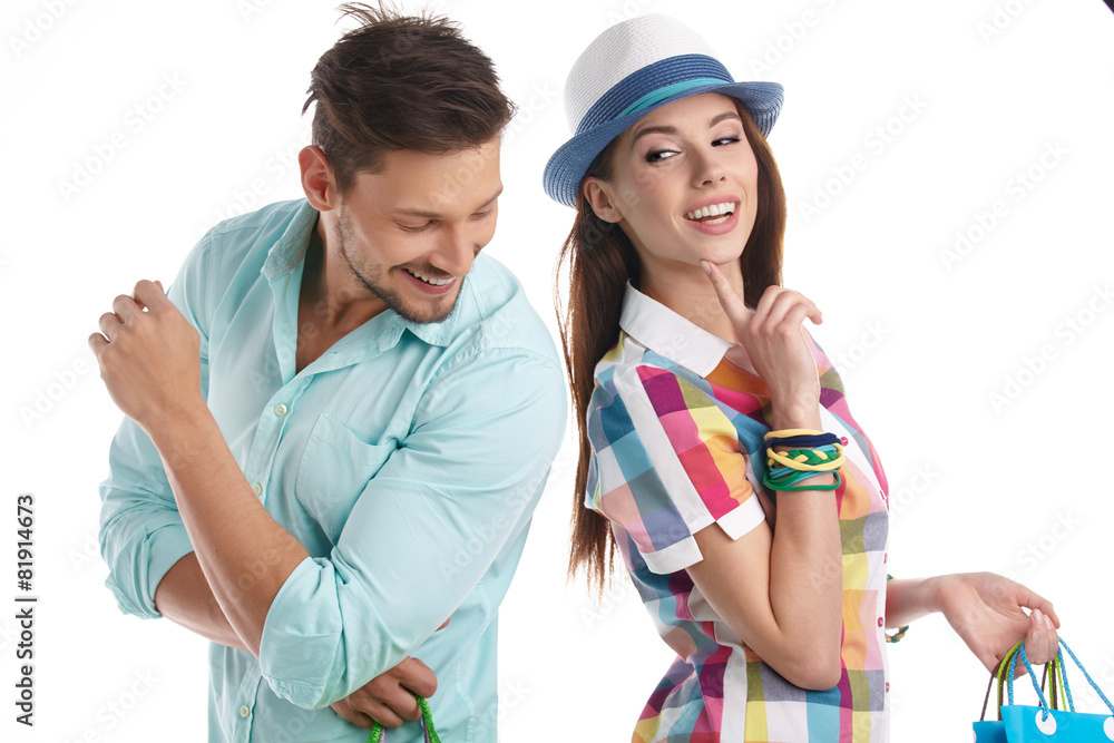 Attractive young couple with shopping bags on white background Attractive young couple with shopping bags on white background