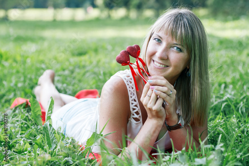 young woman lying on the grass in the park