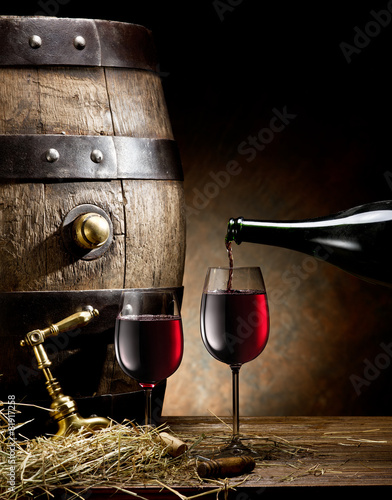 Still-life with glass of wine, bottle and barrel. photo