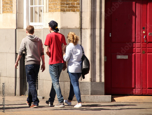 Teenagers walking in a street of London photo