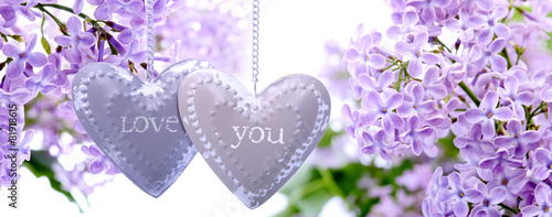 Lilac flowers and metal hearts