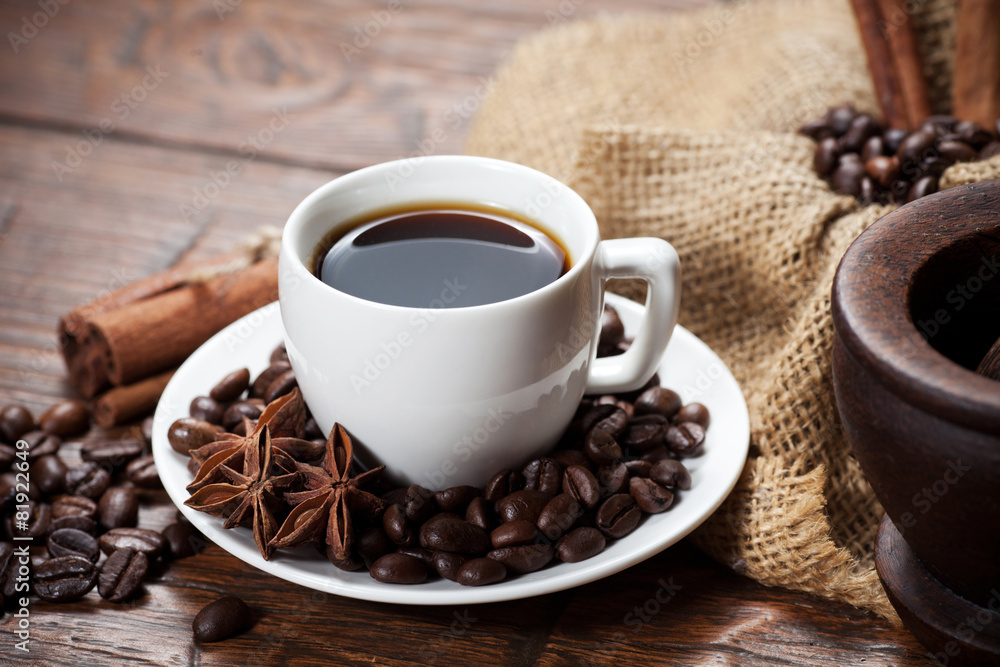 Cup of coffee with beans and spicery Cup of coffee with beans and spicery