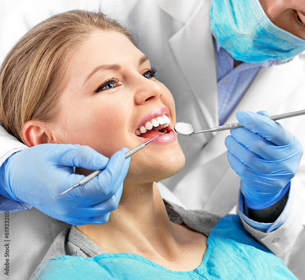 Dental health. Male dentist curing a female patient Dental health. Male dentist curing a female patient