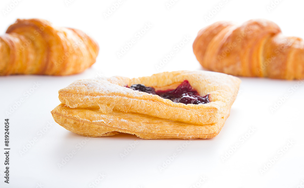 Delicious Cherry puff pastry with croissants isolated on white