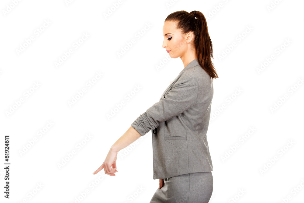 Businesswoman pointing down. Businesswoman pointing down.