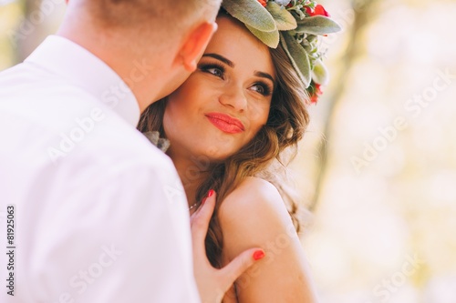 Happy newlyweds in park. Portrait of loving young bride and groo photo