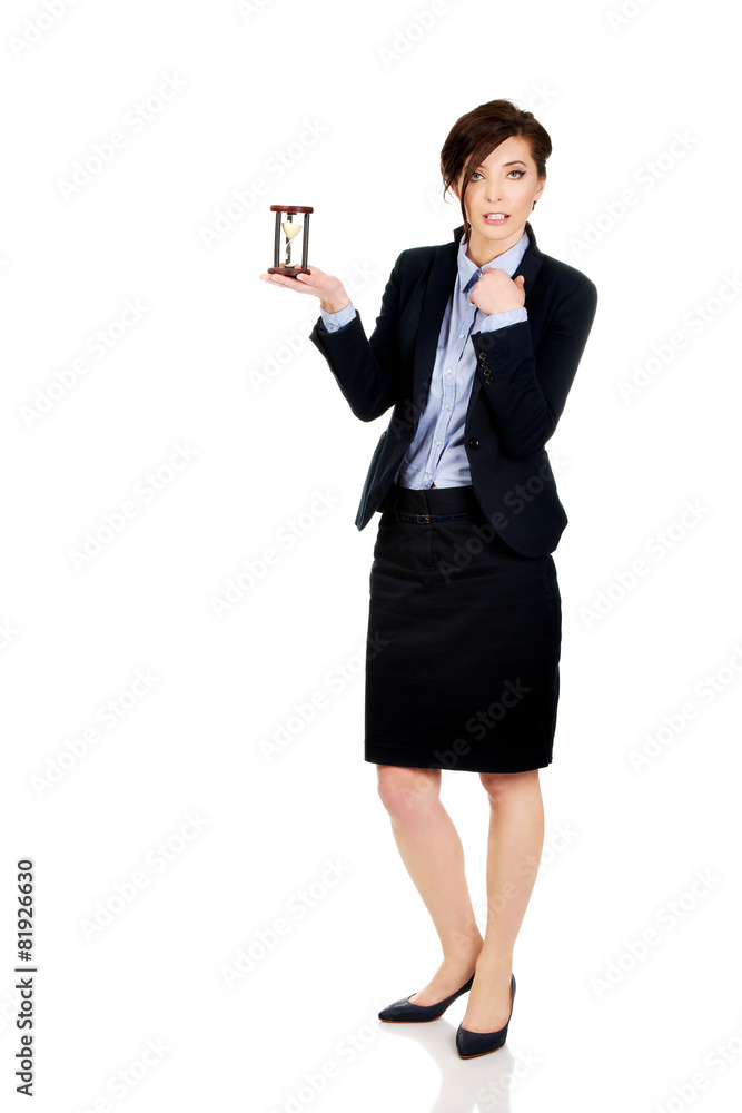 Businesswoman holding hourglass.