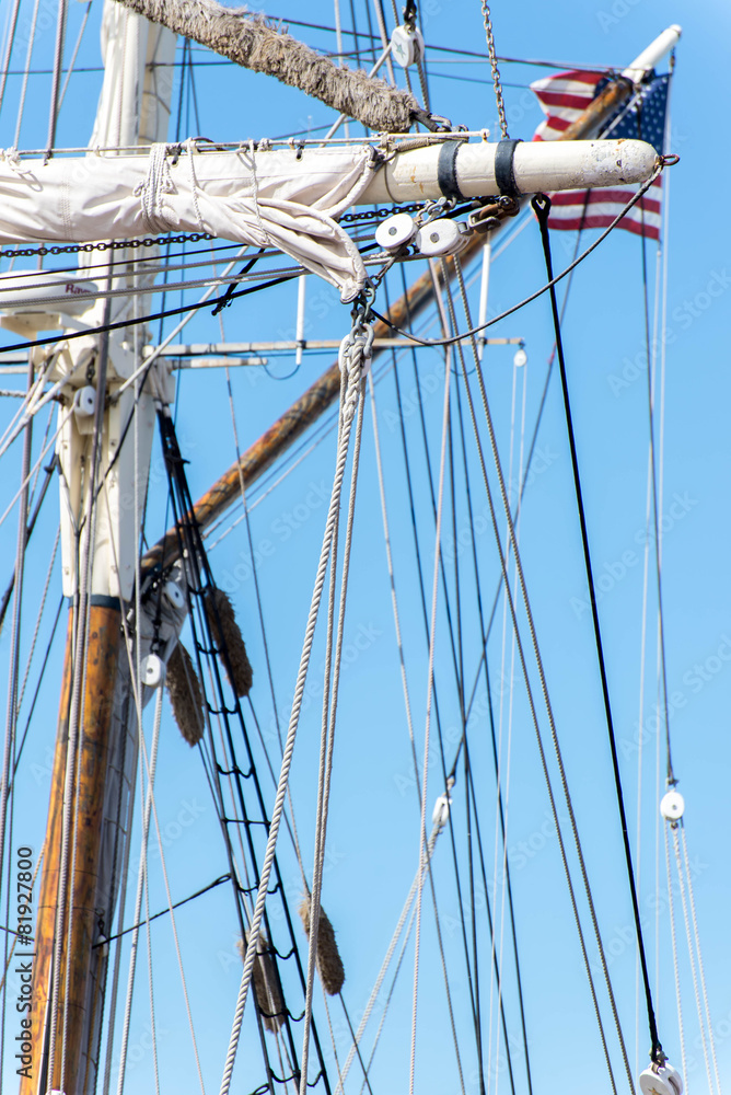 Obraz premium sailboat masts, rigging and rolled up sails