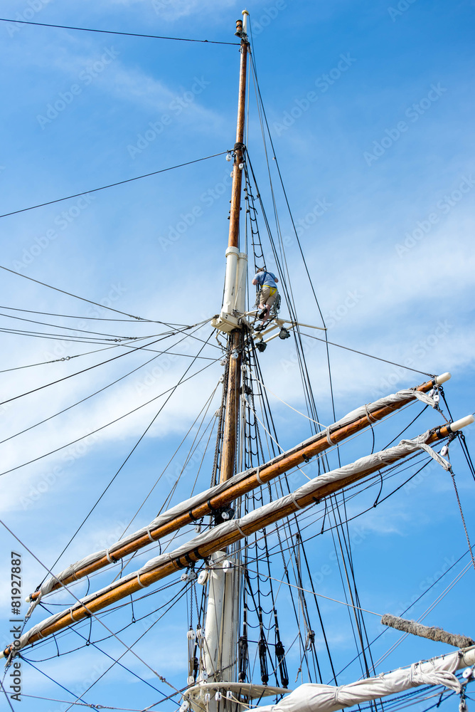 sailboat masts, rigging and rolled up sails sailboat masts, rigging and rolled up sails