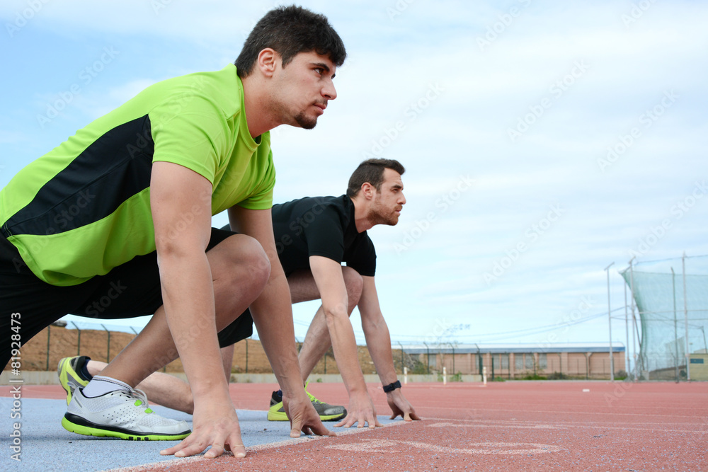 runners at the start of the track runners at the start of the track