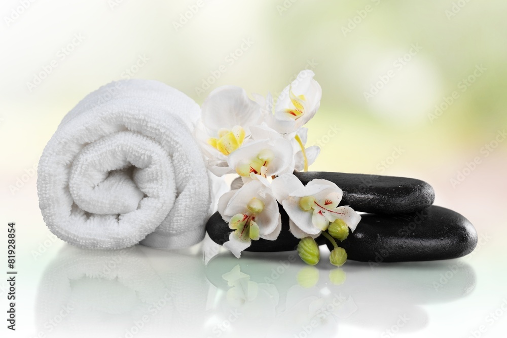 Spa Treatment. Towel, gladiola and pebbles for massage Spa Treatment. Towel, gladiola and pebbles for massage