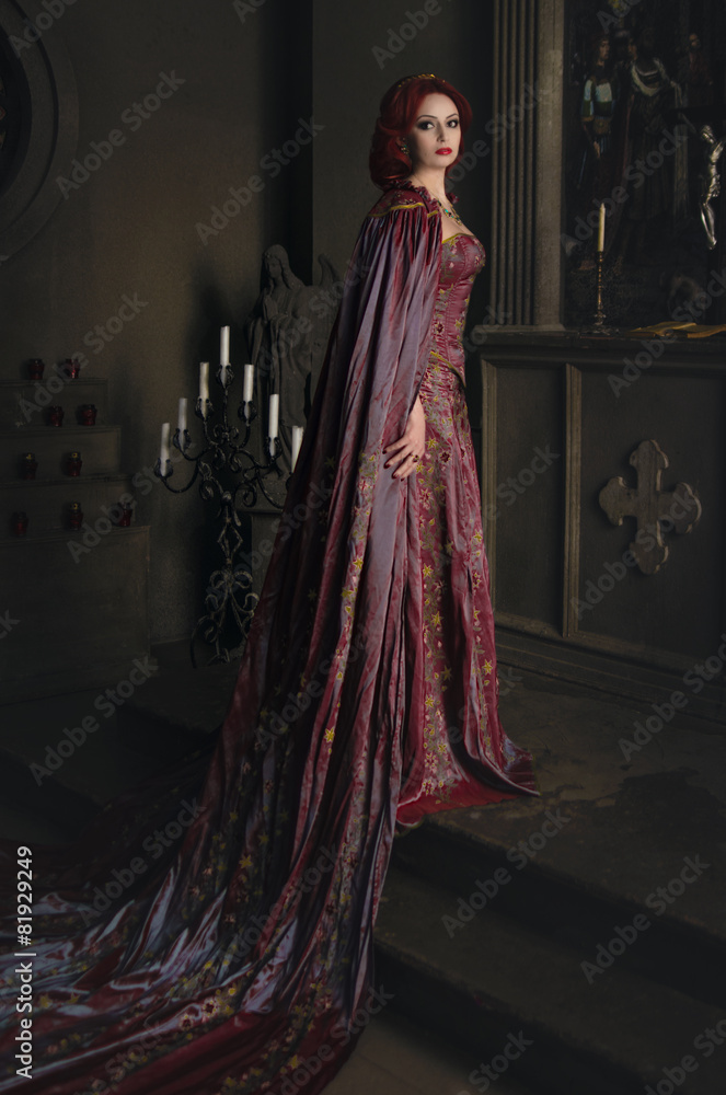 Woman with red hair wearing elegant royal garb 