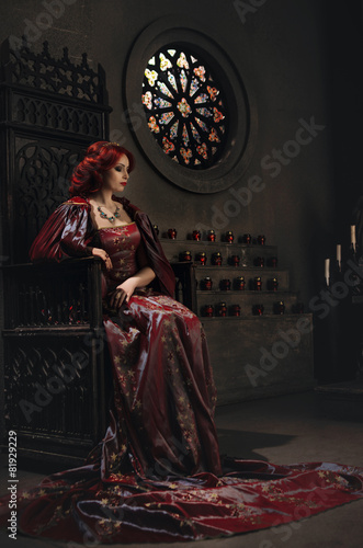 Woman with red hair wearing elegant royal garb