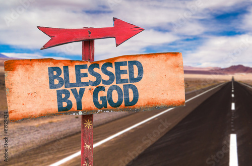 Blessed By God sign with road background photo