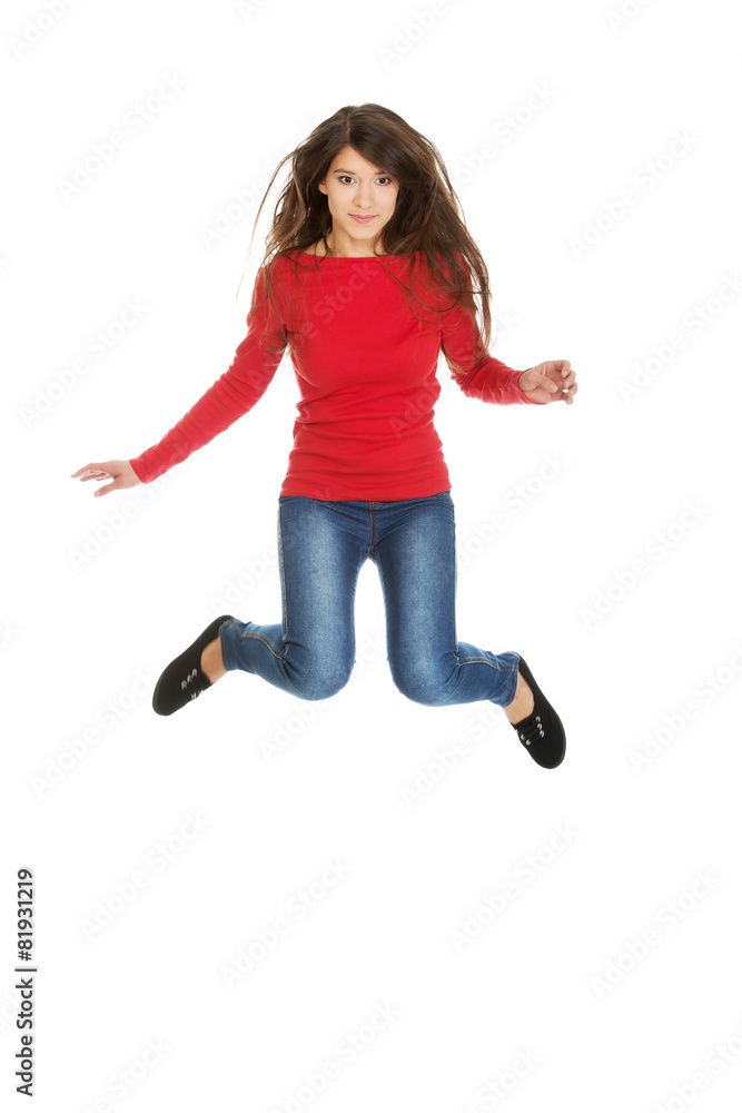 Young woman student jumping.