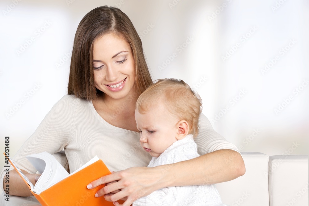 Mother. Mother and baby are looking to play and read tablet Mother. Mother and baby are looking to play and read tablet