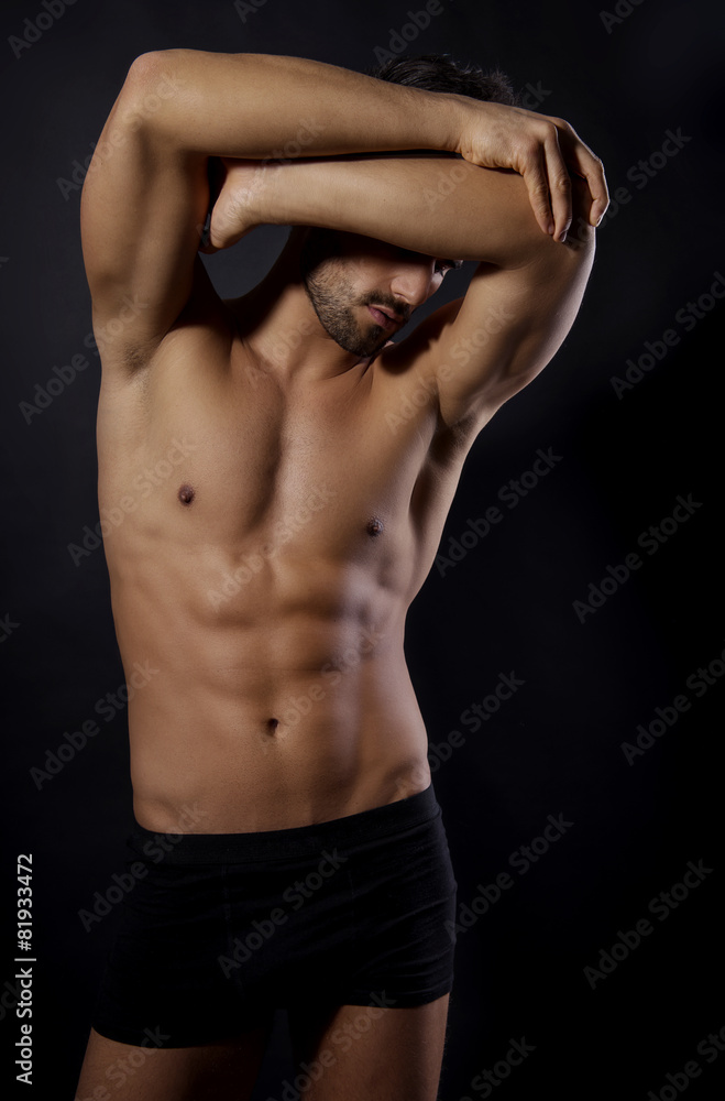 handsome young bodybuilder showing of his fit body and muscles handsome young bodybuilder showing of his fit body and muscles