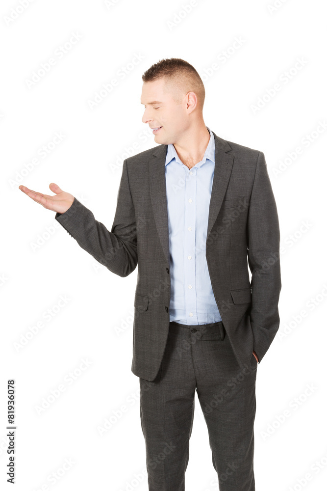 Smiling businessman holding copyspace Smiling businessman holding copyspace
