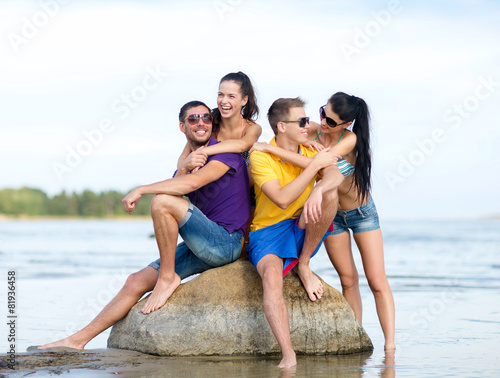 happy friends on summer beach