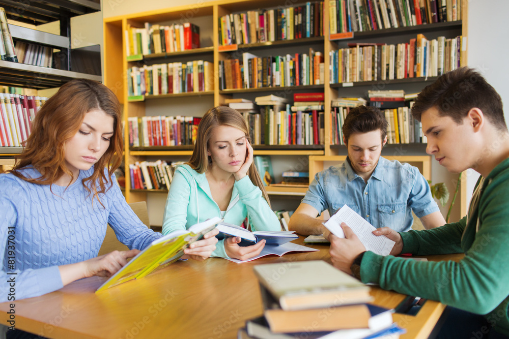 students reading books in library students reading books in library