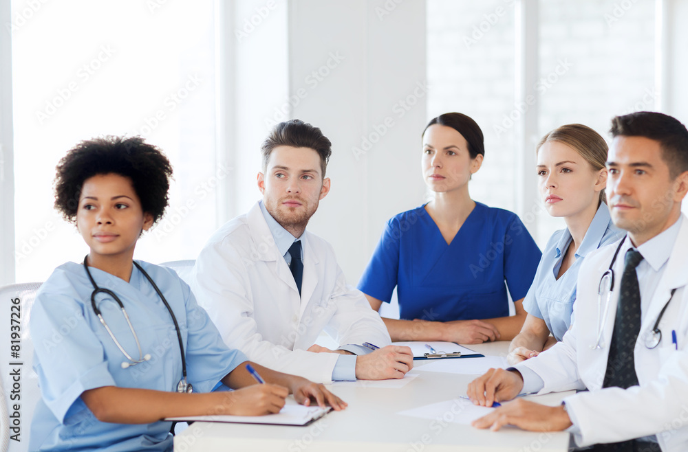 group of happy doctors on conference at hospital