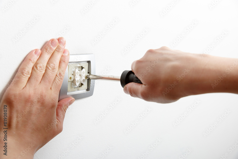 Electrician installing a light switch
