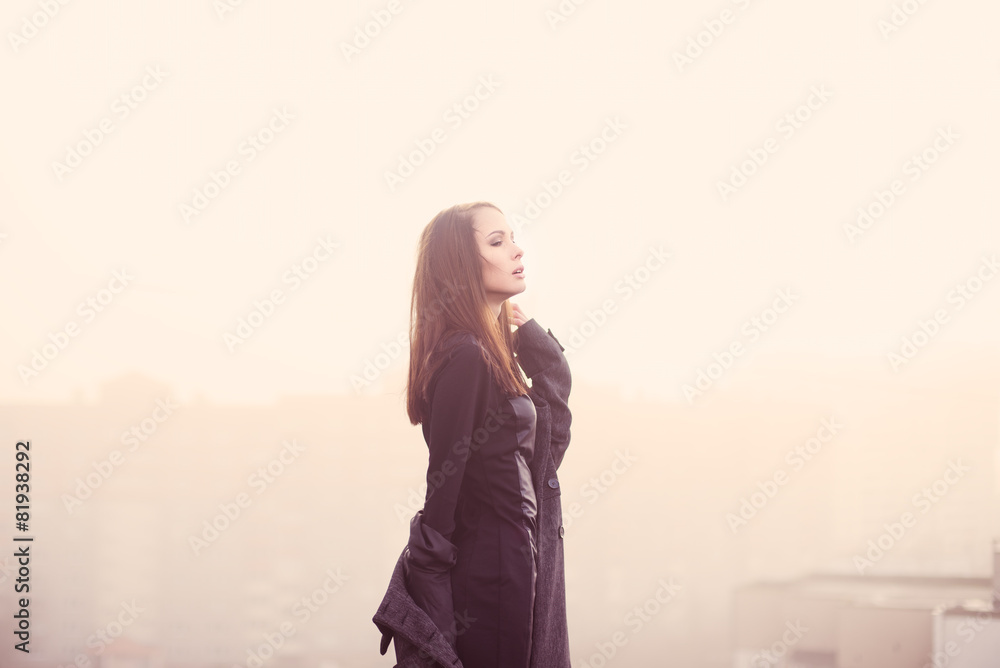 beautiful young girl in black enjoys the freedom in a morning beautiful young girl in black enjoys the freedom in a morning