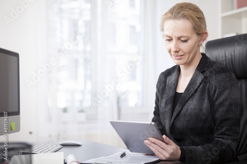 Businesswoman at her Office Using Tablet Computer