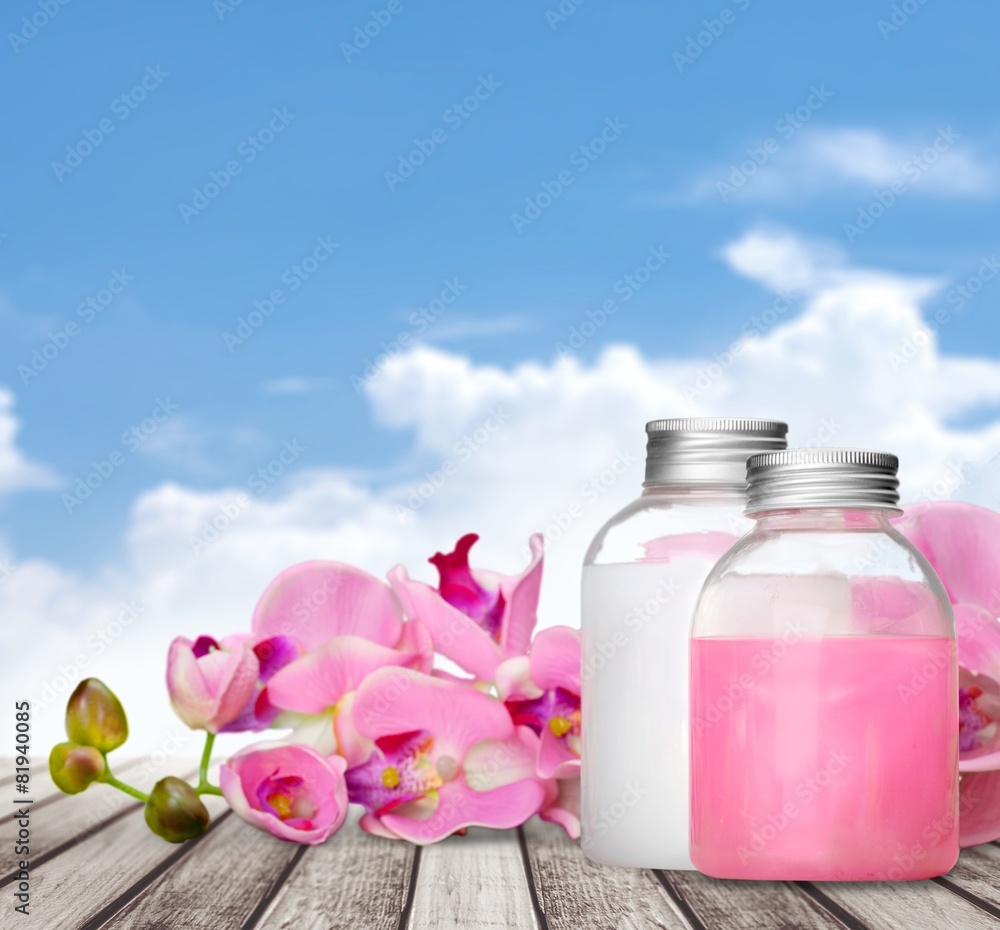 Cosmetics. Pink soap bottles and flowers Cosmetics. Pink soap bottles and flowers