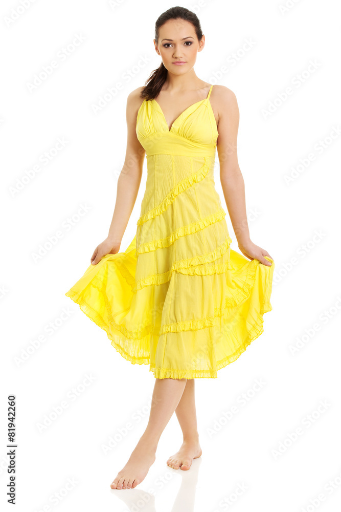 Beautiful female model in yellow dress.