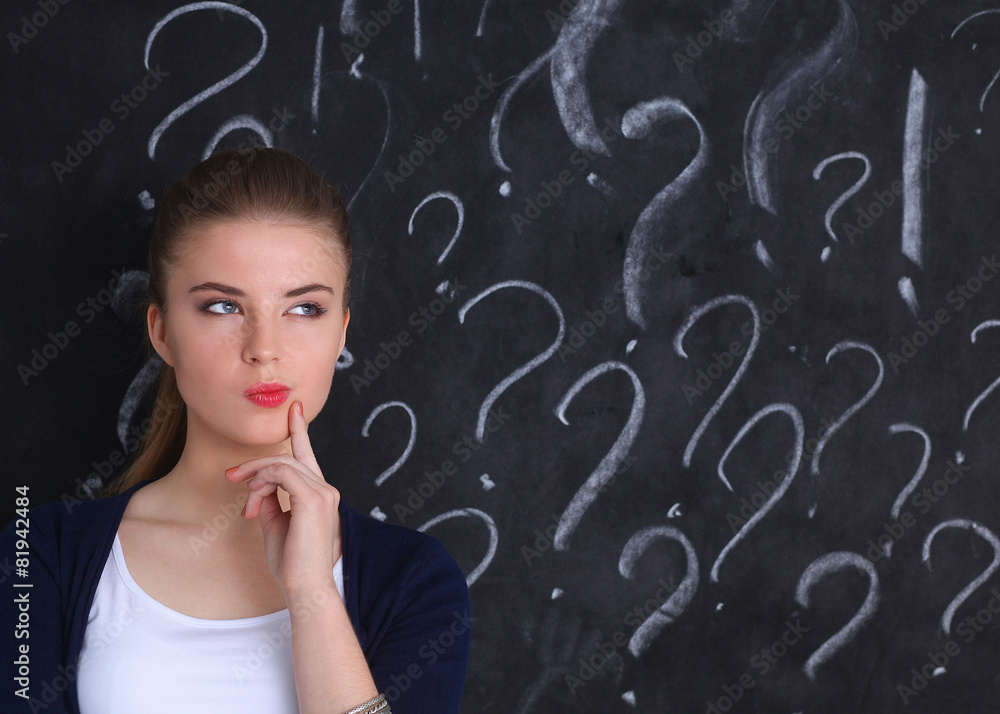Young girl with question mark on a gray background Young girl with question mark on a gray background