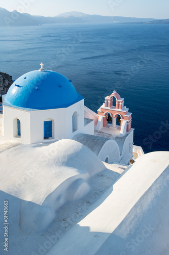 white chapel with blue top on Santorini in Greece