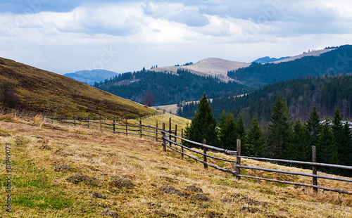 Fence near the meadow path on the hillside