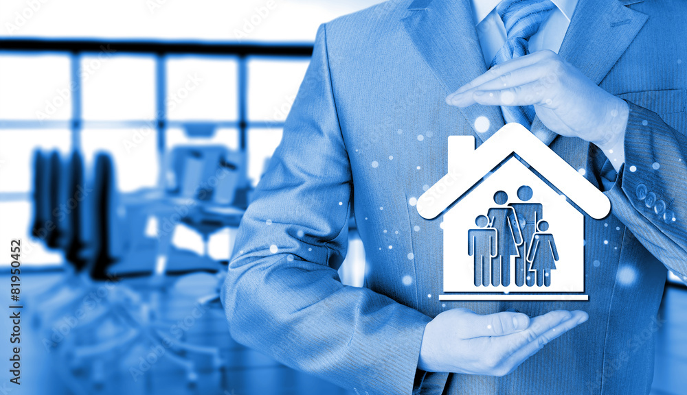 businessman protecting family in home with hands