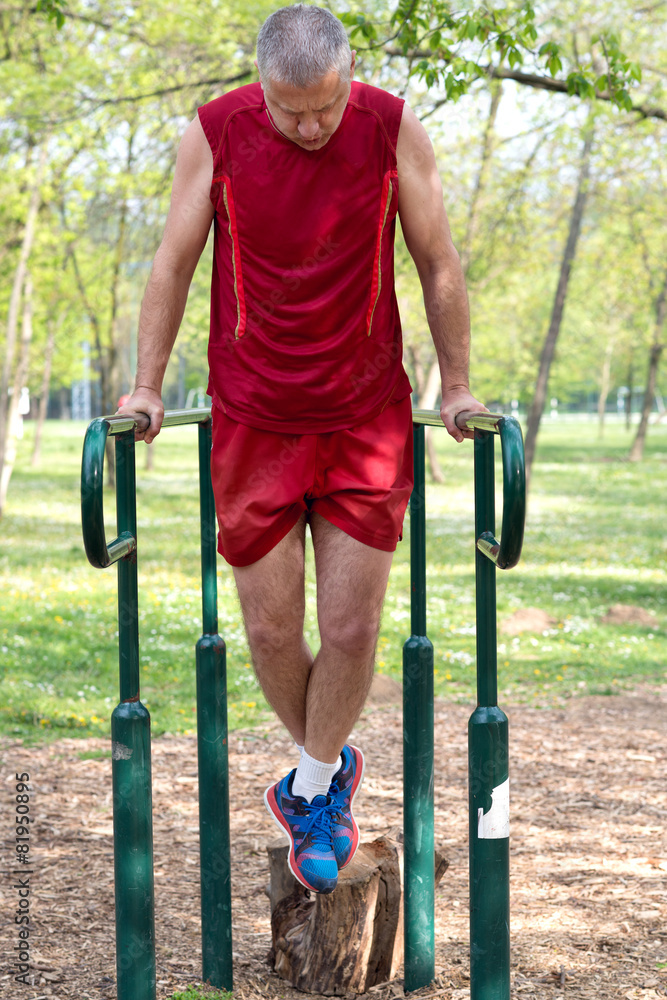 Senior Exercising In Sport Park Senior Exercising In Sport Park