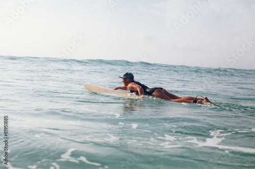 woman surfer swimming in sea © shevtsovy